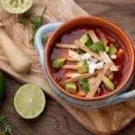 Healthy And Easy Chicken Tortilla Soup In A Bowl With Sliced Lime On The Side