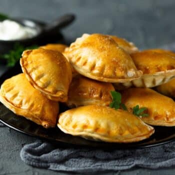 Seriously Amazing Empanadas With Beef 2 Stack Of Empanadas With Beef On A Black Plate