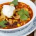 My Family’s Favorite Easy Taco Soup 24 Easy Taco Soup Served In A White Bowl Topped With Greek Yogurt And Tortilla Chips