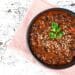 Heartwarming Slow-Cooker Beef Chili With Quinoa In A Black Bowl