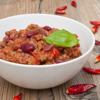 The Perfect Chili Recipe For Spicy Food Lovers 2 The Perfect Chili Recipe In A White Bowl With Chilis Around