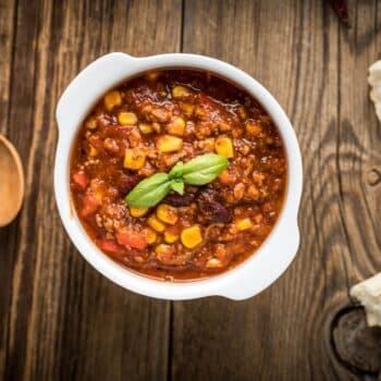 Easy Beef Chili Recipe 2 Easy Beef Chili Recipe With Corn In A White Bowl And A Wooden Spoon On The Side