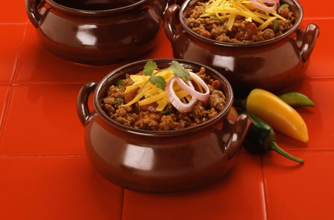 Heartwarming Bbq Bison Chili With Grated Cheddar Cheese On Top