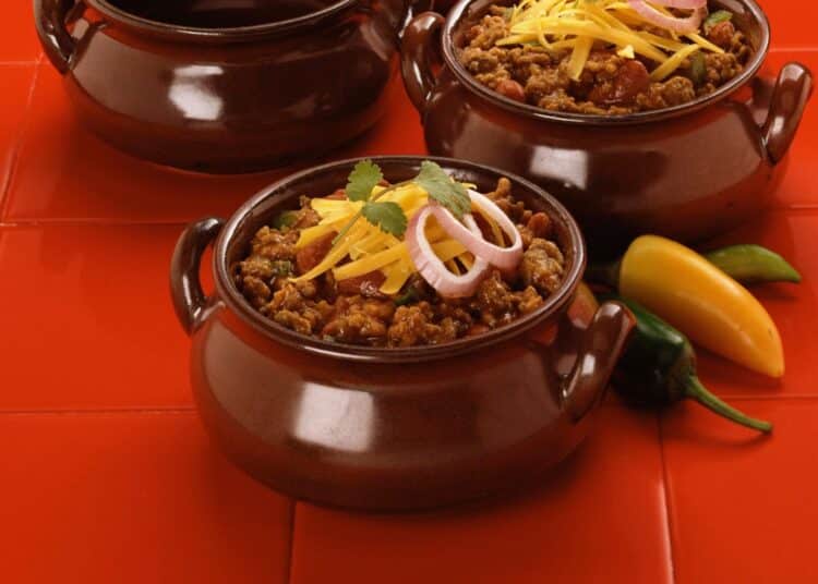 Heartwarming Bbq Bison Chili With Grated Cheddar Cheese On Top