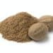 Heap Of Ground Nutmeg And Whole Nutmeg Seeds